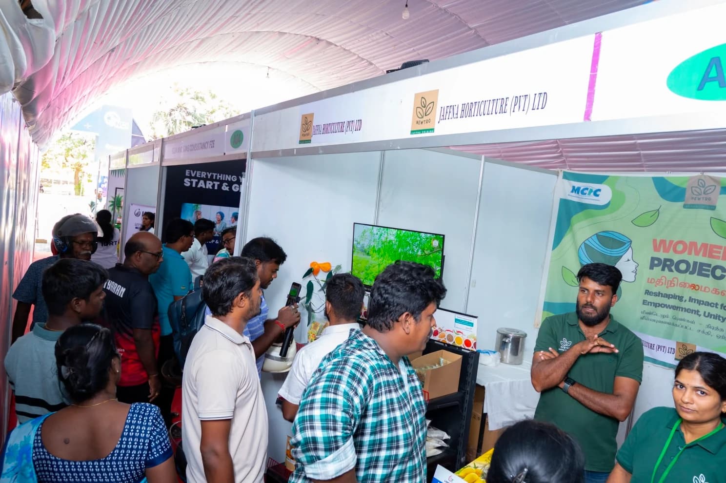 Visitors crowd the exhibition aisle at NITE 2026, talking to exhibitors at the Jaffna Horticulture stall